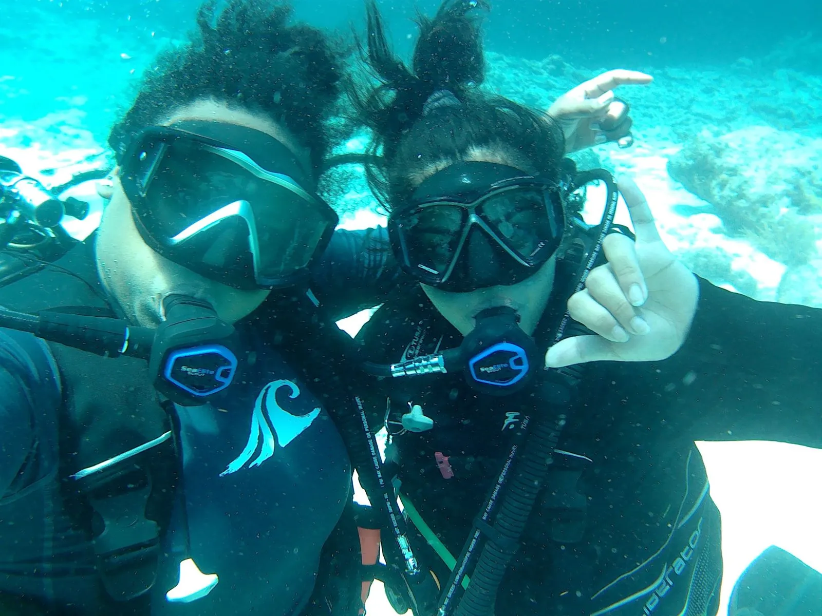 Two scuba divers posing for a photo underwater